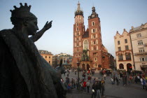 Poland, Krakow, Detail of female figure on monument to the polish romantic poet Adam Mickiewicz by Teodor Rygier in 1898 in the Rynek Glowny market square with Mariacki Basilica or Church of St Mary i...