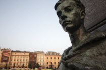 Poland, Krakow, Detail of female figure on monument to the polish romantic poet Adam Mickiewicz by Teodor Rygier in 1898 in the Rynek Glowny market square with Mariacki Basilica or Church of St Mary i...