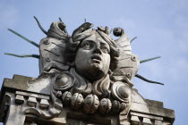 Poland, Krakow, Head of Apollo on top of the entrance to the Palace of Arts built in 1901 for the Society of Fine Arts Friends.