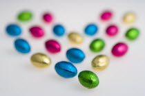 Food, Sweets, Chocolate, Colourful foil wrapped Easter eggs in the shape of a Valentine heart on a white background.