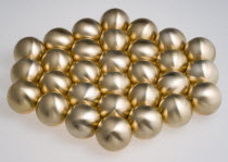 Industry, Machinery, Components, Brass metal lathe turned ball bearings arranged in a hexagon shape on a white background.
