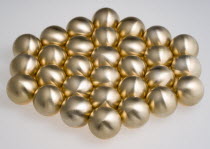 Industry, Machinery, Components, Brass metal lathe turned ball bearings arranged in a hexagon shape on a white background.