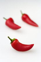 Food, Vegetables, Chillies, Three hot red chilli peppers on a white background.