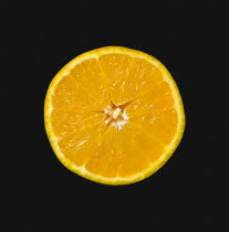 Food, Fruit, Oranges, One single ripe orange cut in half showing core and segments against a black background.