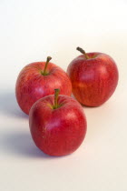 Food, Fruit, Apples, Three ripe red apples against on a white background.