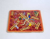 Toys, Games, Board Game, Snakes and Ladders board game with dice and counters for children against a white background.