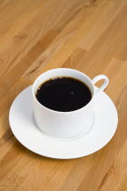 Drinks, Hot, Coffee, Cup and saucer of hot black coffee on a wooden table.