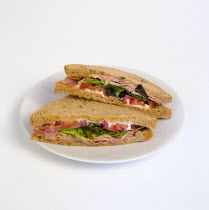 Food, Meal, Snack, Bacon lettuce and tomato BLT sandwich on a white plate against a white background.