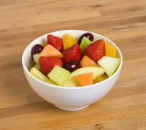 Food, Fruit, Salad, White bowl of fresh fruit salad on a wooden table top.