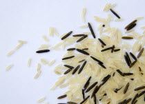 Food, Uncooked, Rice, Wild and basmati rice scattered on a white surface.