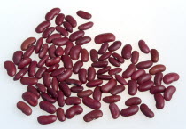 Food, Uncooked, Beans, Red kidney beans scattered on a white surface.