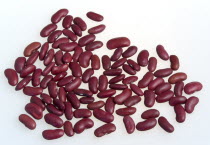 Food, Uncooked, Beans, Red kidney beans scattered on a white surface.