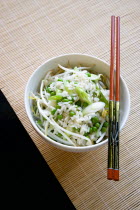 Food, Cooked, Rice, Fried rice with vegetables in a bowl with chopsticks sitting on a bamboo table mat.