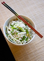 Food, Cooked, Rice, Fried rice with vegetables in a bowl with chopsticks sitting on a bamboo table mat.