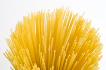 Food, Uncooked, Pasta, Strings of durum wheat spaghetti seen from above against a white background.