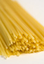 Food, Uncooked, Pasta, Strings of durum wheat spaghetti seen end on against a white background.