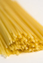 Food, Uncooked, Pasta, Strings of durum wheat spaghetti seen end on against a white background.