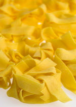 Food, Uncooked, Pasta, Ribbons of durum wheat Pappardelle against a white background.