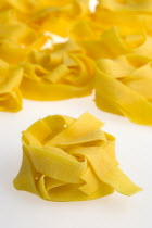 Food, Uncooked, Pasta, Ribbons of durum wheat Pappardelle against a white background.
