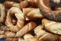 Poland, Krakow, Obwarzaneck, twisted rings of bread strewn with poppy sale, for sale from street vendor's stall.