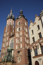 Poland, Krakow, Mariacki Basilica or Church of St Mary overlooking the Rynek Glowny the market square with Hard Rock Cafe to the right.