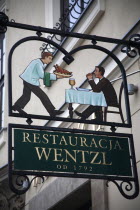 Poland, Krakow, sign for Restaurant Wentzl in the old city.