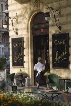 Austria, Vienna, Mariahilf District, Cafe Sperl, The preferred cafe of Adolf Hitler and established for over 120 years. Exterior with waitress taking coffee order inside.