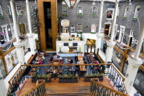 Ireland, County Dublin, Dublin City, Powerscourt Centre restaurants with people at tables beside shops in the enclosed old Georgian townhouse courtyard.