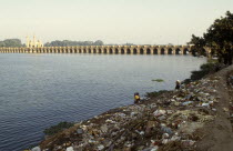 Environment, Litter, View over people doing washing on the litter scattered banks of the Nile toward the Nile Barrages near Qanater.