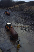 Wales, Dyfed, Stackpole Quay, Workers clearing beached oil from grounded tanker the Sea Empress in 1996.