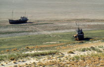 Kazakhstan, Aral Sea, Ship Cemetary, Abandoned and rusting ships on dry area formerly the sea bed.