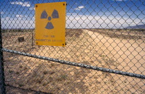 USA, New Mexico, Trinity, Site of first nuclear test in 1945 with warning signs on surrounding wire fence.