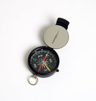 Travel, Navigation, Map Reading, Sighting compass with dial pointing to magnetic north on a white background.