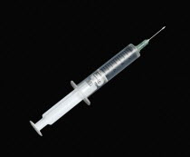 Health, Medicine, Medical Equipment, Hypodermic syringe for giving injections on a black background.