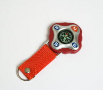 Travel, Navigation, Map Reading, Compass on red strap for child pointing to magnetic north.