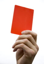 Sport, Ball Games, Referees, Referee showing red sending off dismissal card in raised hand.