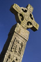 Ireland, County Monaghan, Clones, Celtic Cross against blue sky.
