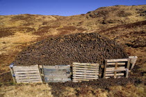 Ireland, County Donegal, Glengash Pass, Turf Stack in barren landscape.