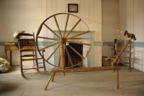 Ireland, County Tyrone, Omagh, Ulster American Folk Park, Spinning wheel in Pennsylvania Log Farmhouse.