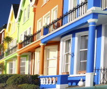 Ireland, County Anrtrim, Whitehead, Colourfully painted terraced houses with balconies.