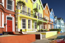 Ireland, County Anrtrim, Whitehead, Colourfully painted terraced houses with balconies.