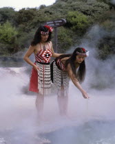 New Zealand, North Island, Rotorua Thermal Pools with Maori girls in traditional dress.