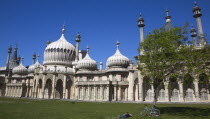 England, East Sussex, Brighton, The Royal Pavilion, 19th century retreat for the then Prince Regent, Designed by John Nash in a Indo Sarascenic style, with cyclist relaxing in the gardens.