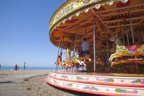 England, East Sussex, Brighton, Carousel on the pebble beach promenade.