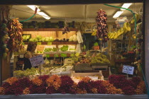 Italy, Veneto, Venice, Centro Storico, Local grocer with display of fresh fruit, vegetables and chillies. Woman in interior.