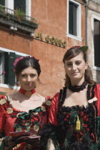 Italy, Veneto, Venice, Portrait of two young women wearing traditional costume to promote Venice Casino.