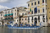 Italy, Veneto, Venice, Grand Canal, Participants in the Regata Storico historical Regatta held each September, wearing traditional costume and rowing ornately decorated blue and silver gondola approac...