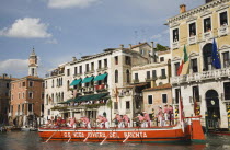 Italy, Veneto, Venice, Grand Canal, Participants in the Regata Storico historical Regatta held annually in September wearing traditional costume approaching the Rialto bridge with onlookers gathered o...