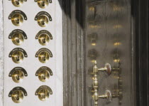 Italy, Veneto, Venice, Brass doorbells with nameplates on restored facade of apartment building entrance.
