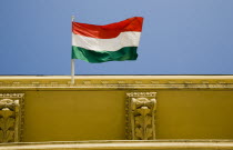 Hungary, Pest County, Budapest, Hungarian flag flying from top of partly seen renovated building on Pest bank of the River Danube.